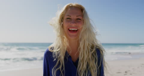Joyful Caucasian Woman on Sunny Beach Smiling