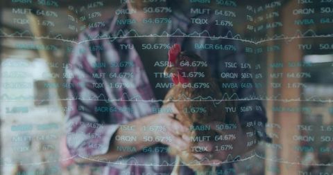 Farmer cradling hen amid floating financial charts and data overlay in rustic barn