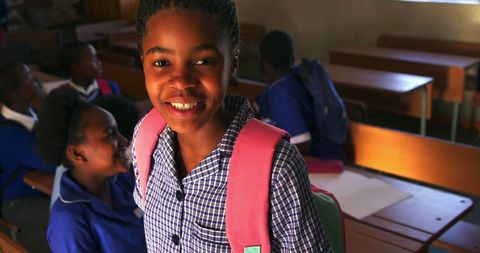 Smiling Schoolchild Wearing Backpack Inside Classroom - Download Free Stock Images Pikwizard.com