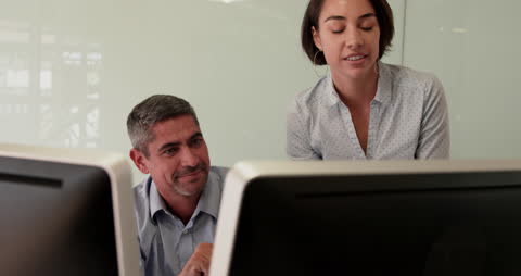 Team Collaboration at Office Desk with Computers
