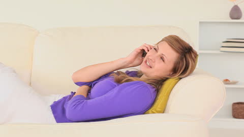 Woman Relaxing on Sofa Having Phone Conversation