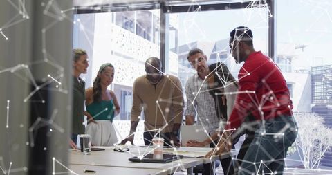 Diverse team collaborating on digital strategy in modern conference room with tech overlay