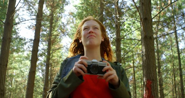 Woman Holding Camera in Forest, Enjoying Nature and Photography - Download Free Stock Images Pikwizard.com