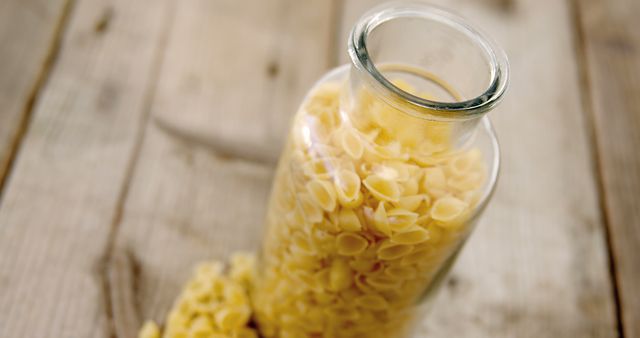 Glass Jar Full of Pasta Shells on Wooden Surface - Download Free Stock Images Pikwizard.com
