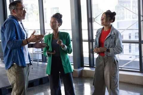 Diverse team collaborating in bright modern office, casual brainstorming and discussion