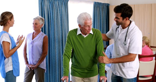 Team of caregivers assisting elderly man with walker in care home - Download Free Stock Images Pikwizard.com