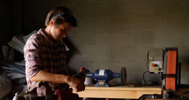 Young Carpenter Using Smartphone in Workshop - Download Free Stock Images Pikwizard.com