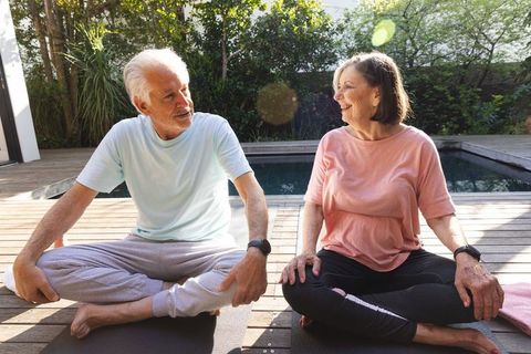 Senior Couple Sitting Outdoors Sparking Lively Conversation