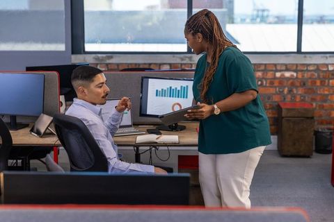 Colleagues Collaborating in Modern Open-Plan Office Environment