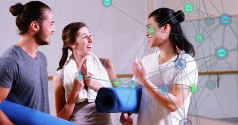 Laughing trio sharing yoga mats with digital wellness network overlay