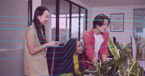 Office Workers Collaborating with Technology in Modern Workspace