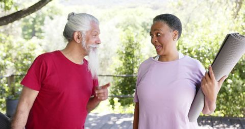 Senior Friends Engaging in Outdoor Yoga Conversation