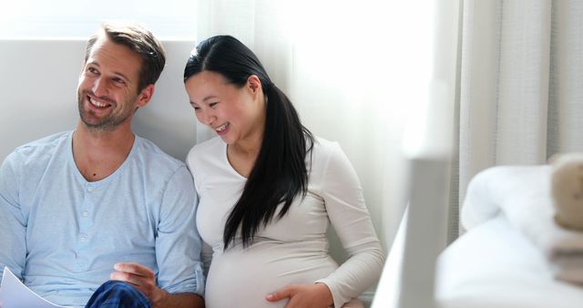 Happy Multiracial Couple Expecting Baby Relaxing at Home - Download Free Stock Images Pikwizard.com