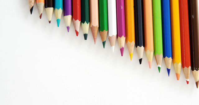 Various colored pencils arranged in a diagonal line on a clean white background. Ideal for use in advertisements for art supplies, educational material, stationery promotions, and creative workshops.