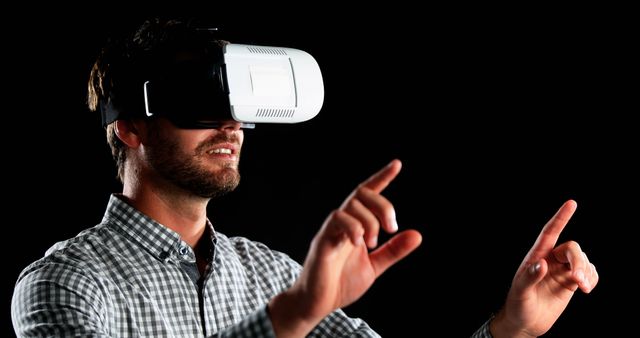 Man using virtual reality headset, engaging with augmented reality through advanced digital technology. Ideal for use in technology presentations, innovative product advertisements, or educational materials showcasing modern tech advancements.