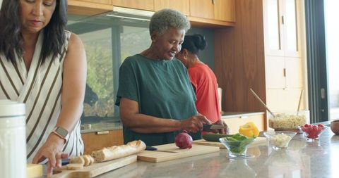 African American Women Cooking on Sunlit Modern Kitchen Island Preparing Healthy Meals