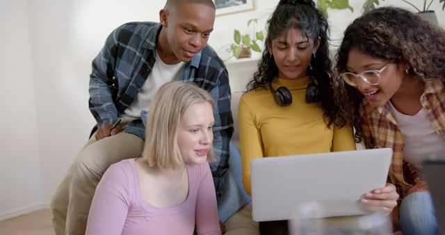 Diverse Group of Young Friends Enjoying Shared Laptop Experience at Home - Download Free Stock Images Pikwizard.com