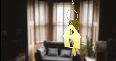 Golden House Key Chain in Cozy Living Room Scene