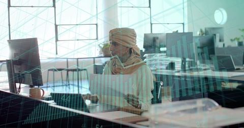 Businesswoman analyzing charts in modern office environment