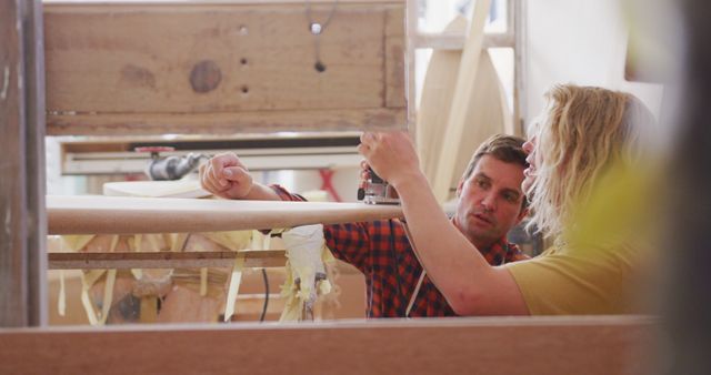 Craftsmen Working Together Shaping Surfboards in Workshop - Download Free Stock Images Pikwizard.com