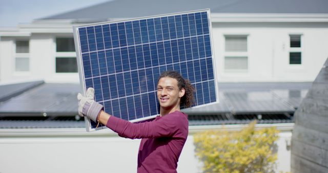 Smiling Technician Carrying Solar Panel in Residential Area - Download Free Stock Images Pikwizard.com