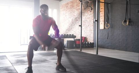 Male Athlete Performing Battle Rope Workout in Industrial Gym