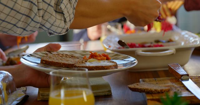 Family having food on dining table at home. Person serving food on the plate 4k