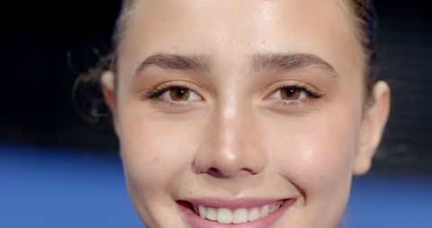 Young Woman in Makeup Smiling Close-Up in Studio
