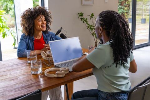 African american women recording podcast and chatting with laptop, microphone, headphones