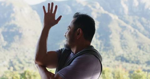 Man Embracing Serenity Amidst Stunning Mountain Views