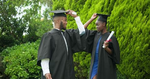 Graduates capturing milestone moment outdoors