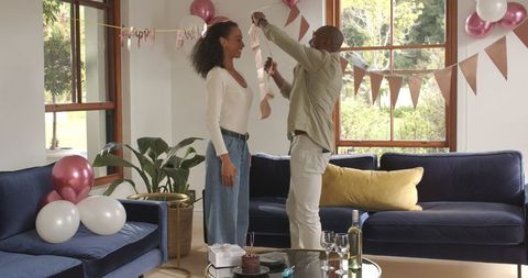 Couple Celebrating Birthday at Home with Festive Decoration