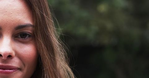 Natural Beauty Woman Outdoors Half Face Close-Up