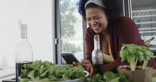 Woman Enjoying Cooking Little Details on Smartphone in Modern Kitchen - Download Free Stock Images Pikwizard.com