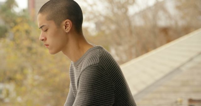 Young Man with Buzzed Hair Deep in Thought Outdoors - Download Free Stock Images Pikwizard.com