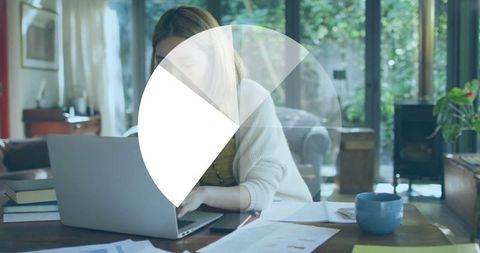 Focused Woman Working from Home Office with Charts and Laptop