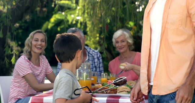 Family Outdoor Picnic with Smiling Faces and Fresh Food - Download Free Stock Images Pikwizard.com