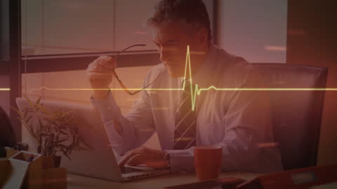 Businessman Using Laptop with Data Visualization Overlay