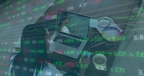 Woman Analyzing Stock Market Data on Laptop in Home Office