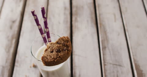 Cookie and Milk on Rustic Wooden Table with Straws