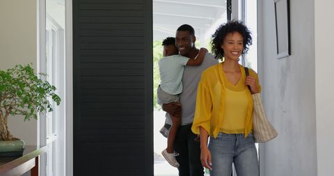 Happy Family Entering New Home with Laughter