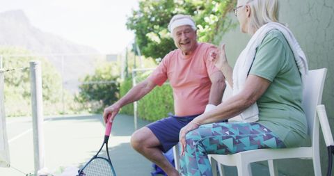 Senior couple enjoying tennis outdoors, embracing active lifestyles