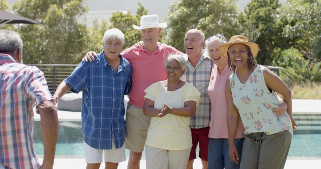 Smiling Senior Friends Enjoying Outdoor Gathering by Pool - Download Free Stock Images Pikwizard.com