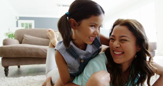 Happy Mother and Daughter Laughing on Living Room Floor - Download Free Stock Images Pikwizard.com