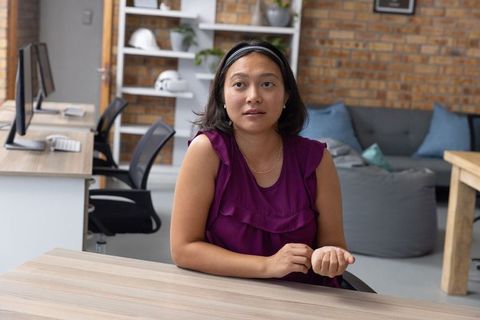 Asian Businesswoman in Contemporary Open-Plan Office Setting