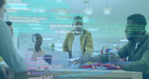 Tech professional collaborating in innovative workspace with code overlay