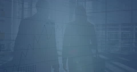 Silhouettes of Businesspeople with Financial Graphs Overlay