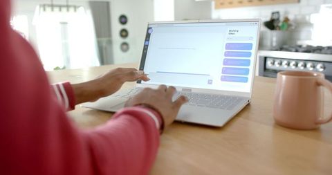 woman typing on laptop with AI chatbot in bright kitchen interior - Download Free Stock Images Pikwizard.com