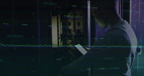 It technician analyzing server rack with tablet in data center
