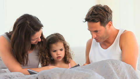 Parents Reading Storybook with Daughter in Cozy Home Environment